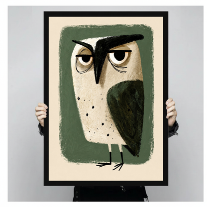 Framed grumpy green owl canvas held by a person against a light neutral background.