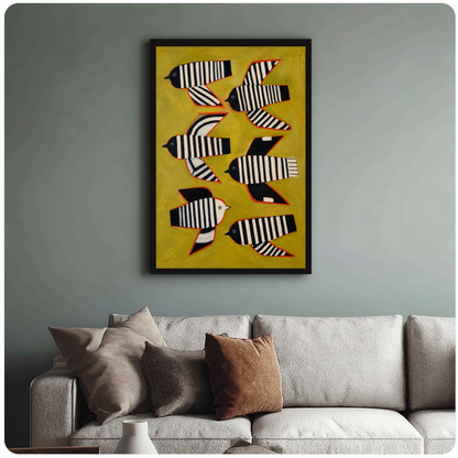 Framed six striped folk birds canvas above a neutral sofa with cushions against a muted wall.