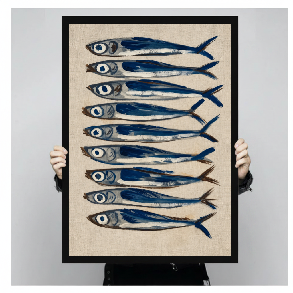 Framed nine blue sardines canvas held by a person against a light neutral background.