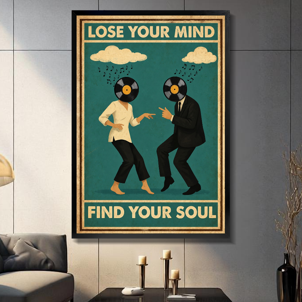 Black framed vinyl head dancing couple canvas on a dark paneled wall beside warm candles.
