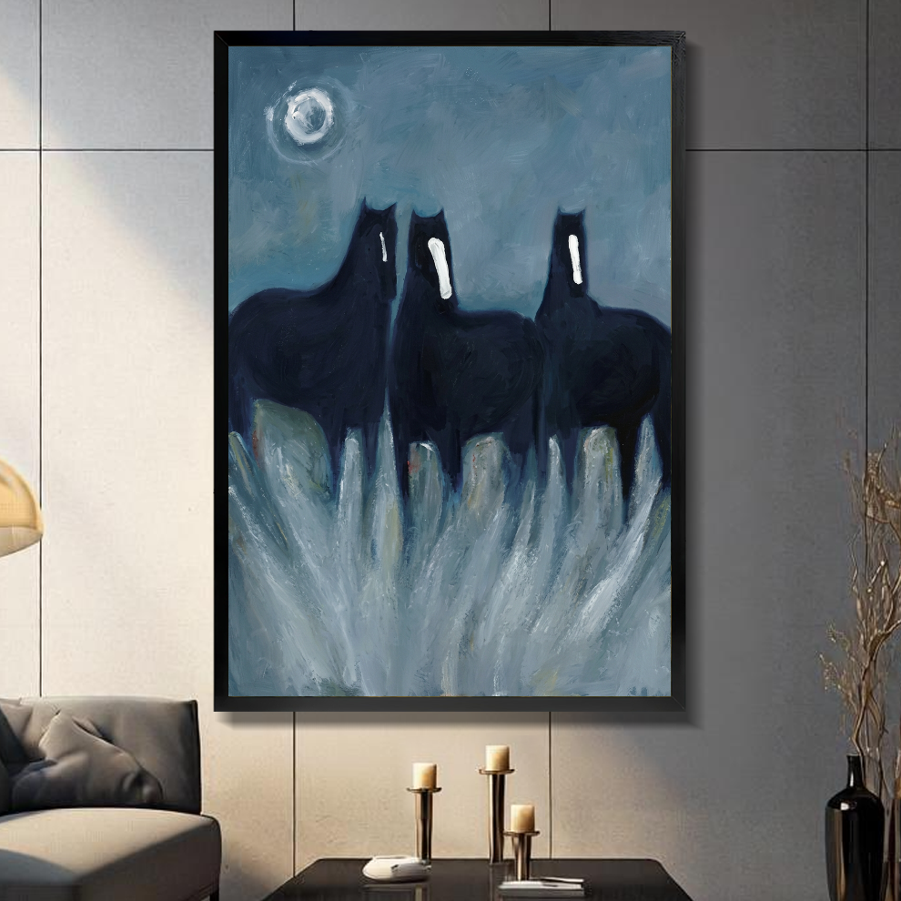 Black framed three ghostly black horses canvas on a dark paneled wall beside warm candles.