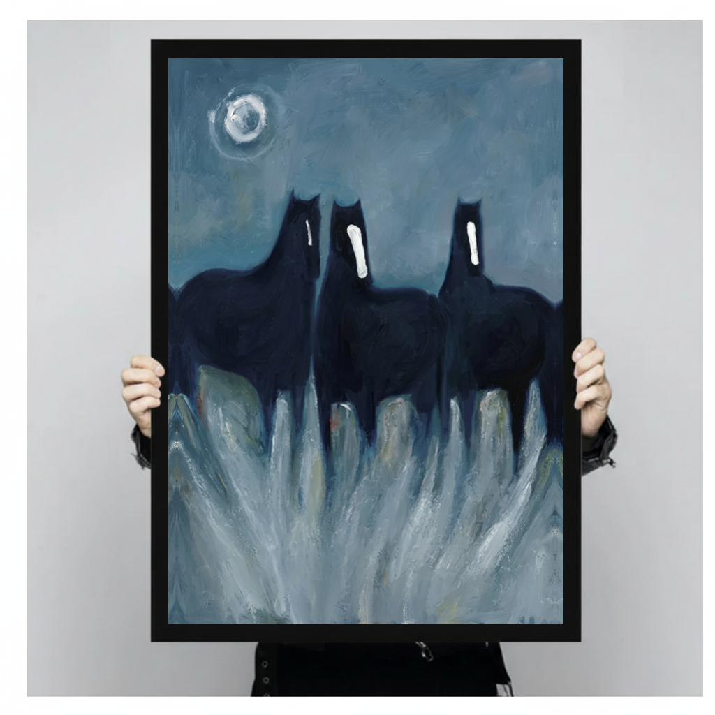 Framed three ghostly black horses canvas held by a person against a light neutral background.