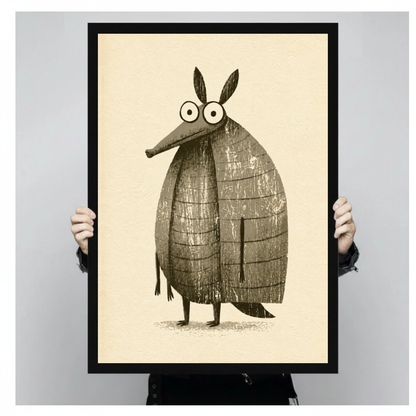 Framed funny little armadillo canvas held by a person against a light neutral background.