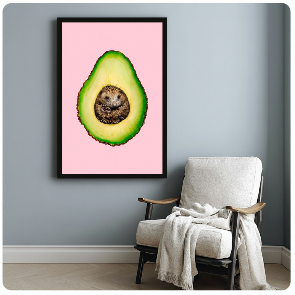 Framed avocado hedgehog canvas beside a pale reading chair on a blue gray wall.