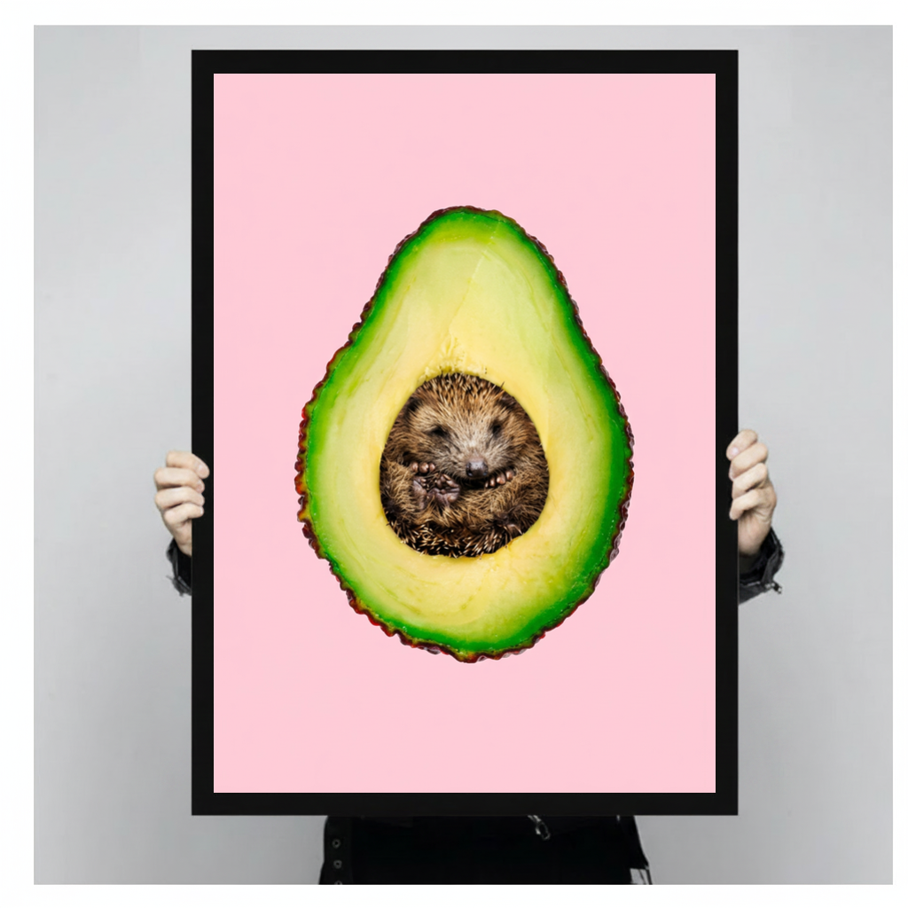 Framed avocado hedgehog canvas held by a person against a light neutral background.