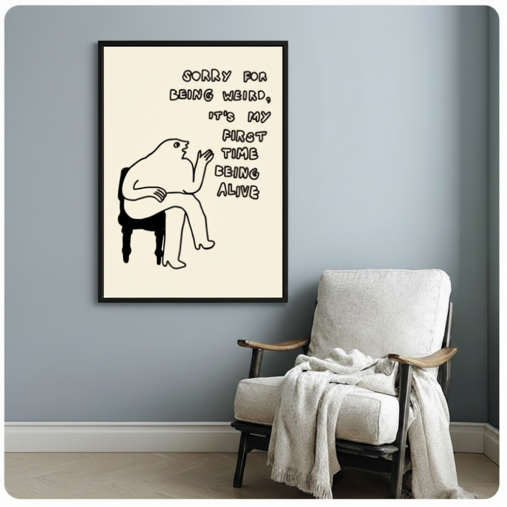 Black framed funny weird quote minimalist line art poster above white linen accent chair in cozy living room