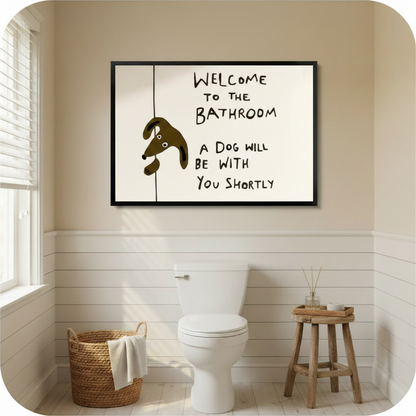 Welcome to the bathroom a dog will be with you shortly humorous line art in black frame above toilet in beige shiplap bathroom – woven basket wood stool natural window light brown cartoon dog cream background funny dog quote bathroom canvas