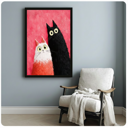 Black framed modern whimsical impasto oil painting small fluffy white cat with orange-tipped ears and tall slender black cat side by side both staring forward with oversized lime green eyes and bewildered expressions on bold magenta pink heavily textured background canvas print on pale blue-grey wall beside white wood arm lounge chair with draped cream linen throw - charming black white cat duo pink wall art for cozy reading nook decor
