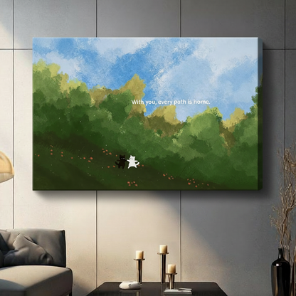 Black and white cat couple "With you every path is home" gallery wrap canvas art with blue sky and green hills above a dark console table with candle holders in a contemporary living room