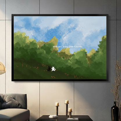 Whimsical black and white cat duo "With you every path is home" black framed canvas art in lush green landscape above a dark console table with candle holders in a modern living room