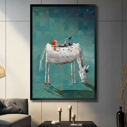 Whimsical child on white horse black float frame canvas wall art on dark gray tile wall above console table with candles and dried botanicals