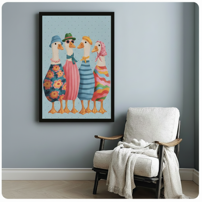Black framed whimsical fashionable ducks squad canvas art showing four charming white ducks in floral striped and rainbow outfits with hats and accessories on a soft blue polka dot background, displayed beside a white linen armchair with a cream throw