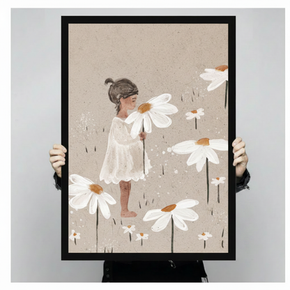 Person holding a large black framed canvas art print of a little girl in a white dress surrounded by giant white daisy flowers showing print size scale and soft watercolour texture detail