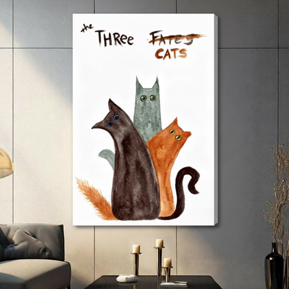 Stretched canvas whimsical The Three Cats watercolor wall art featuring a dark brown cat a tall slender teal-gray cat and a rust orange cat grouped together with wide quirky eyes and bold hand-lettered The Three Fates crossed out Cats title in loose expressive watercolor style on a white background, hung on a gray panel wall above a gray sofa