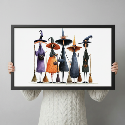 Person in a cream knit sweater holding a large horizontal black framed whimsical Halloween witch squad with brooms canvas art print with five tall spindly witches in purple orange black and green robes wearing distinctive pointed hats and carrying broomsticks in watercolor style on a white background