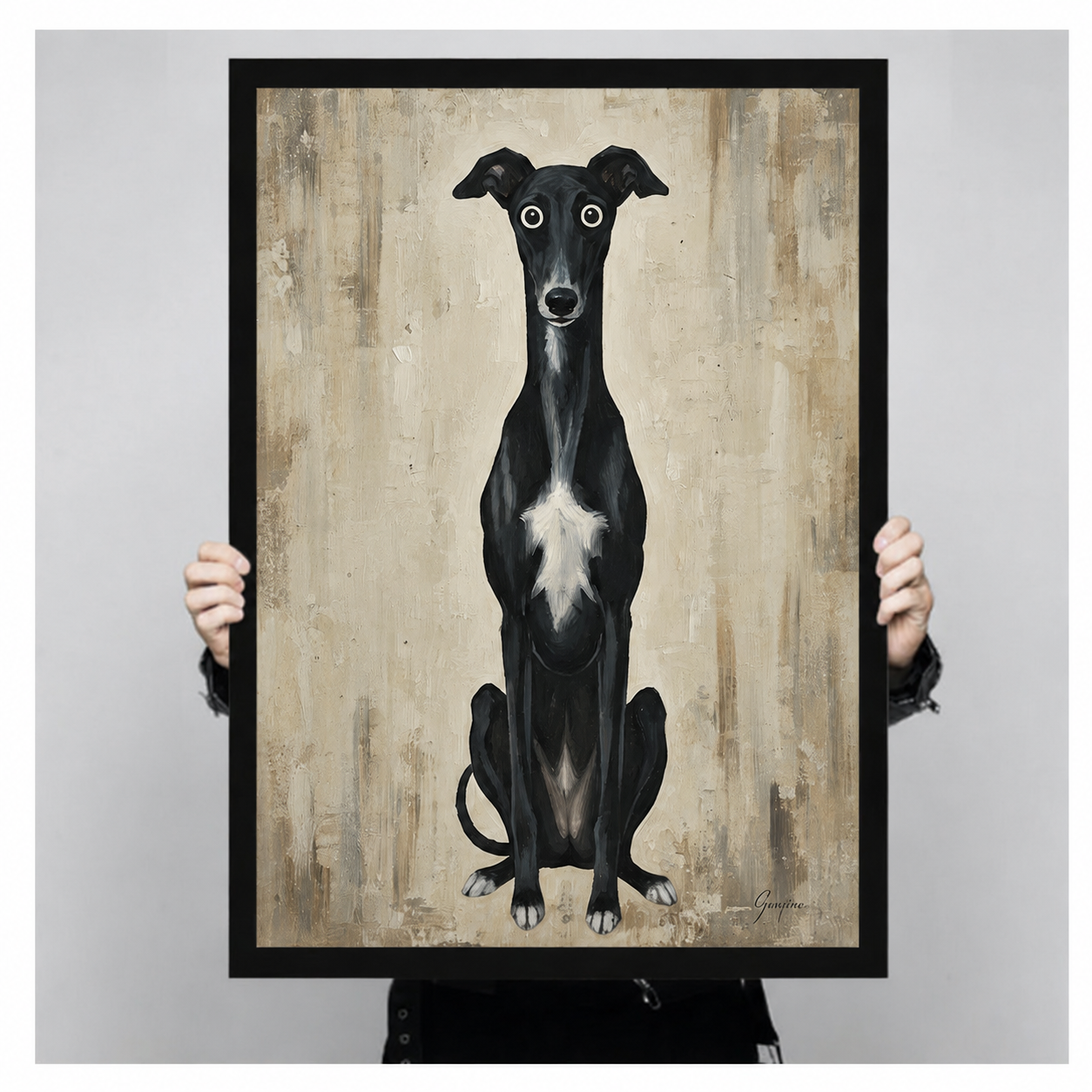 Person holding large black framed whimsical black greyhound whippet dog art print with big round eyes on aged beige textured background in neutral home interior
