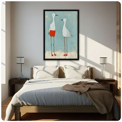 Framed whimsical white bird pair art print with teal wash background, displayed above a minimalist bedroom bed in natural light
