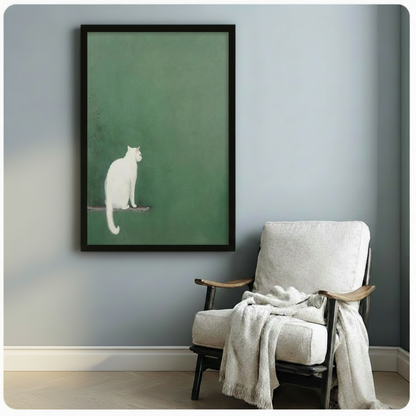 Framed minimalist white cat sage green wall art beside wooden accent chair with linen throw - serene Japanese-style cat canvas print for reading nook or study