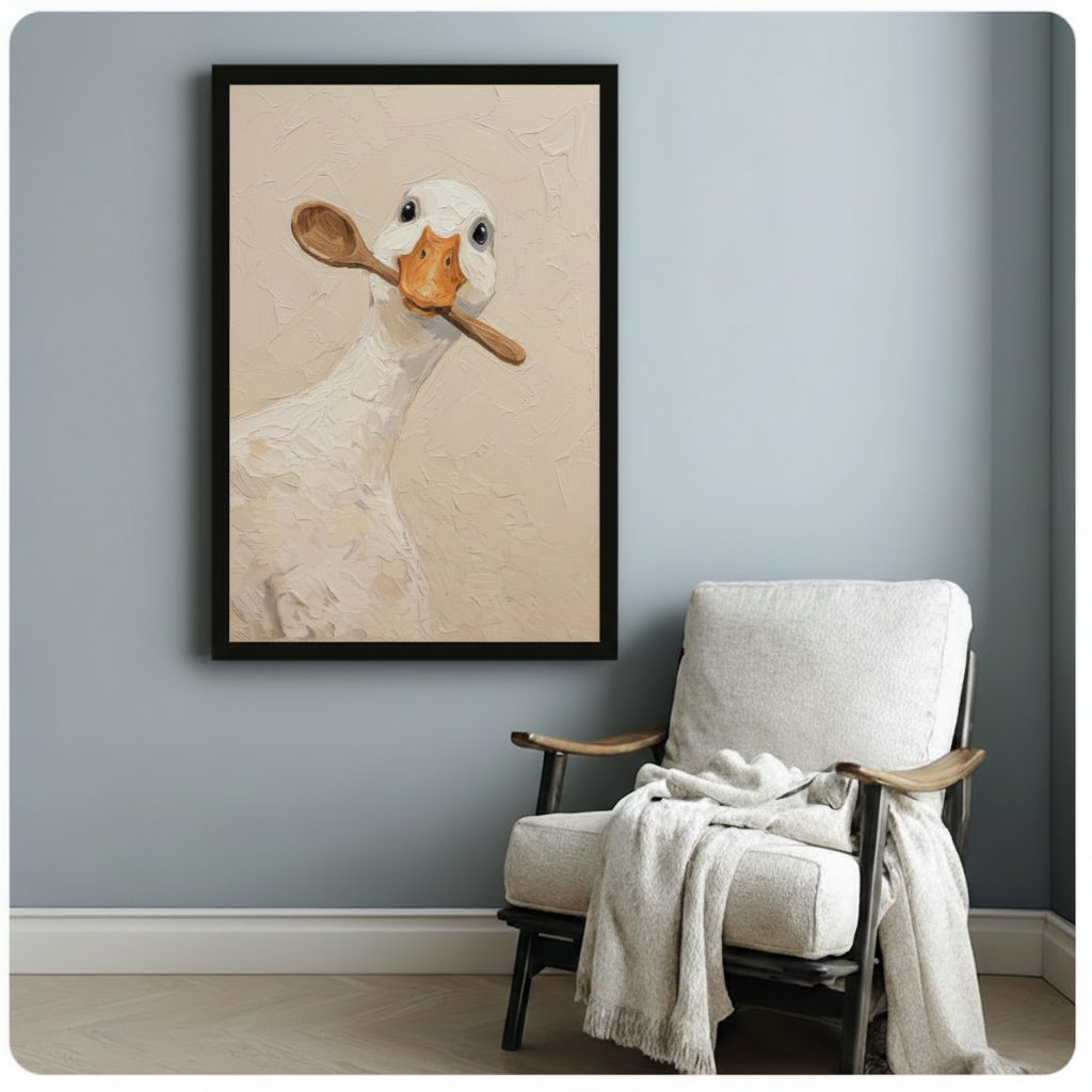 Black framed duck with wooden spoon oil painting on a blue-gray wall above a linen armchair with cozy blanket