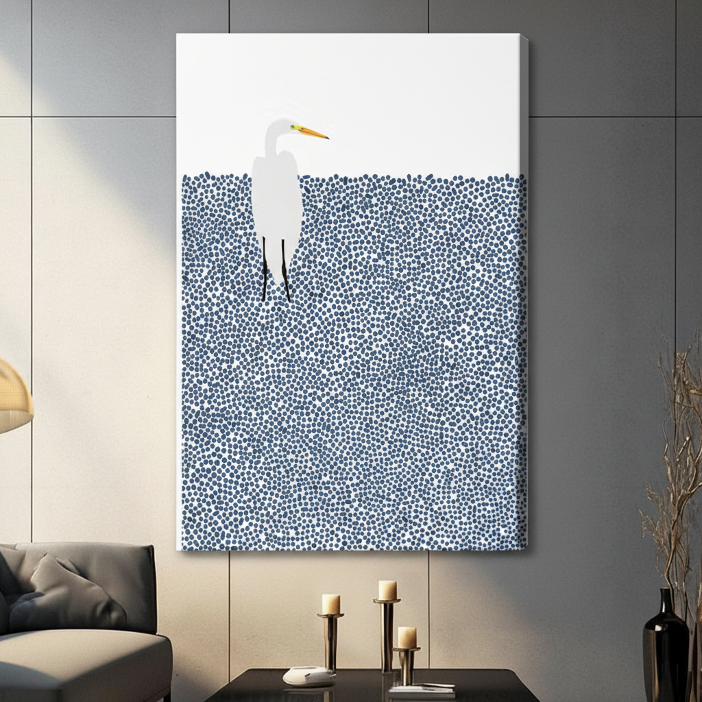 Unframed canvas print of a white great egret wading in a pointillist navy blue water field on a white background hung in a modern dark grey living room