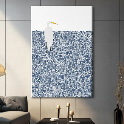 Unframed canvas print of a white great egret wading in a pointillist navy blue water field on a white background hung in a modern dark grey living room