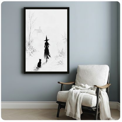 Framed black and white ink-style canvas of a witch walking through a foggy winter scene with a sitting black cat, styled beside a cozy armchair on a blue-grey wall