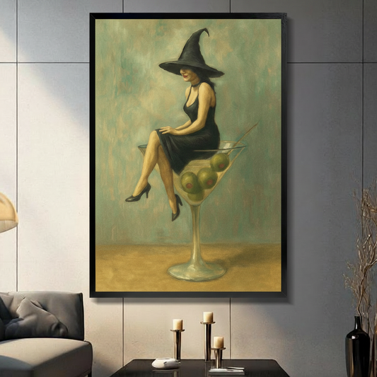 Framed canvas wall art of a elegant witch in a black dress and wide-brim hat sitting on a giant martini glass with olives, vintage oil painting style, displayed in a modern living room