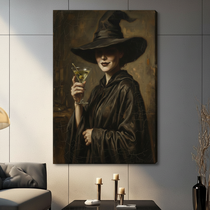  Framed gothic witch wall art print of a dark-robed woman with wide-brim pointed hat and olive martini, hung on blue-grey wall above linen armchair