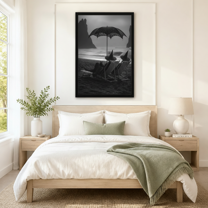 Oversized framed black and white gothic wall art of witches and a black cat on a misty beach, displayed above a neutral linen bed in a Scandinavian-style bedroom
