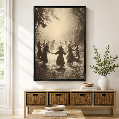Black-framed vintage sepia witches dancing in forest circle wall art displayed above a wicker storage console – gothic Halloween wall decor