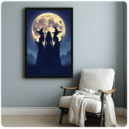 Dark silhouettes of three witches standing beneath a luminous full moon gothic night scene wall art framed print beside armchair blue-gray wall