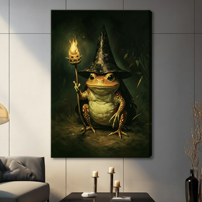 Gallery wrap stretched canvas of a round textured golden toad in a tall pointed black wizard hat and flowing dark cloak seated front-facing and raising a gnarled branch staff with a blazing orange flame at its tip bold expressive eyes and detailed warty skin deep emerald forest background with dramatic warm candlelight glow whimsical fantasy toad illustration hung frameless on a gray marble paneled wall above a charcoal sofa with white candle holders