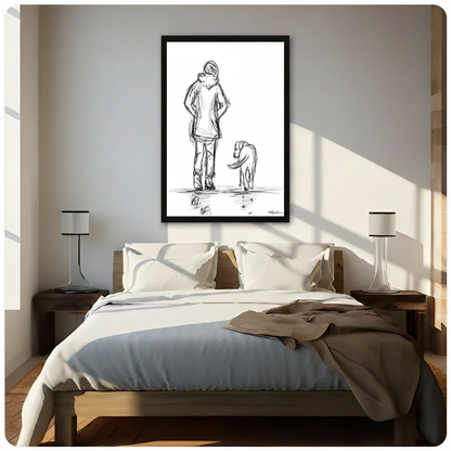 Framed minimalist woman and dog sketch wall art hung above a wooden bed frame in a sunlit neutral bedroom with warm white walls