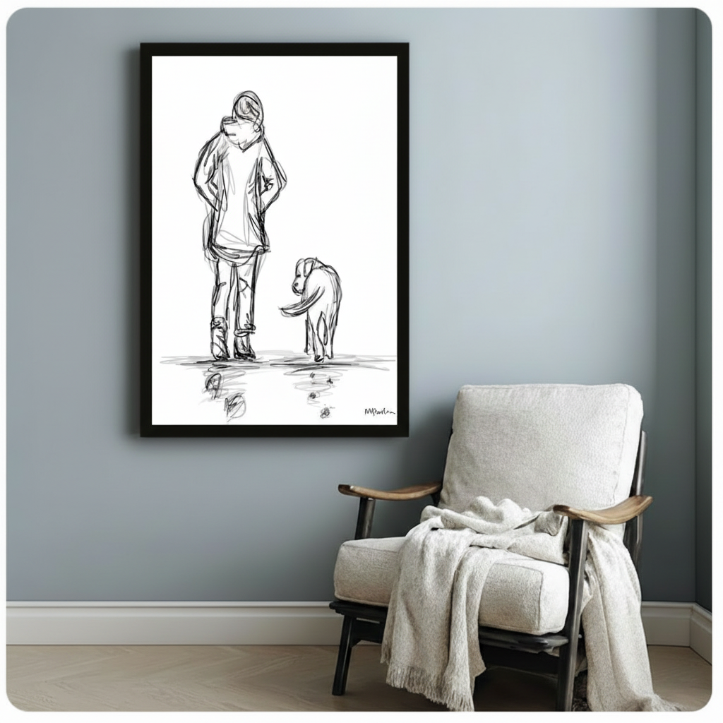 Black framed minimalist dog and owner sketch art print beside a white linen armchair on a soft blue-grey wall