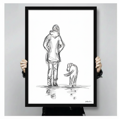 Two hands holding a black framed woman and dog pencil sketch print, clearly showing print dimensions, frame depth, and line art detail