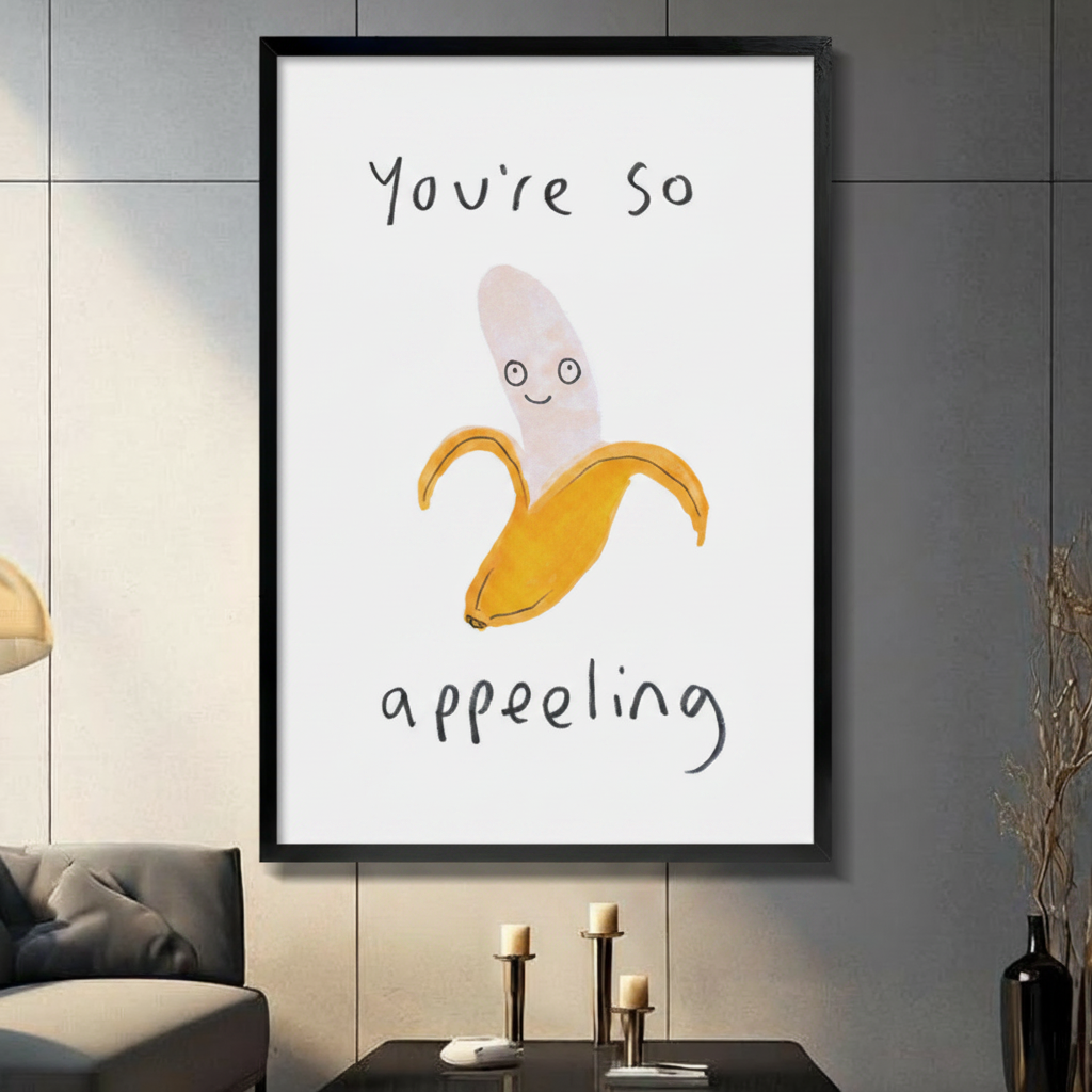 Black framed "You're So Appealing" banana pun art print on grey wall – quirky hand-drawn minimalist décor in contemporary interior
