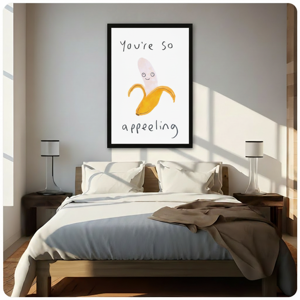 Funny banana pun wall art in black frame above bed – "You're So Appealing" minimalist print in bright Scandinavian-style bedroom