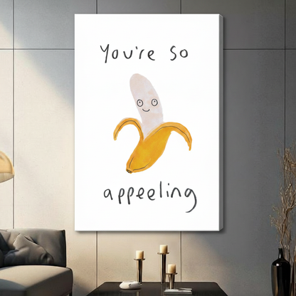 Unframed canvas wall art of smiling peeled banana with "You're So Appealing" pun text, large format display on grey wall with candles